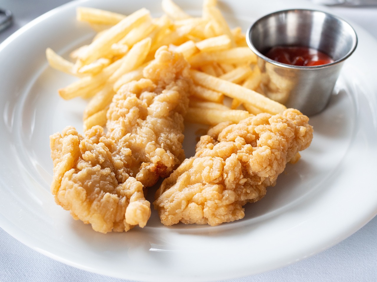 A small plate of chicken tenders and fries