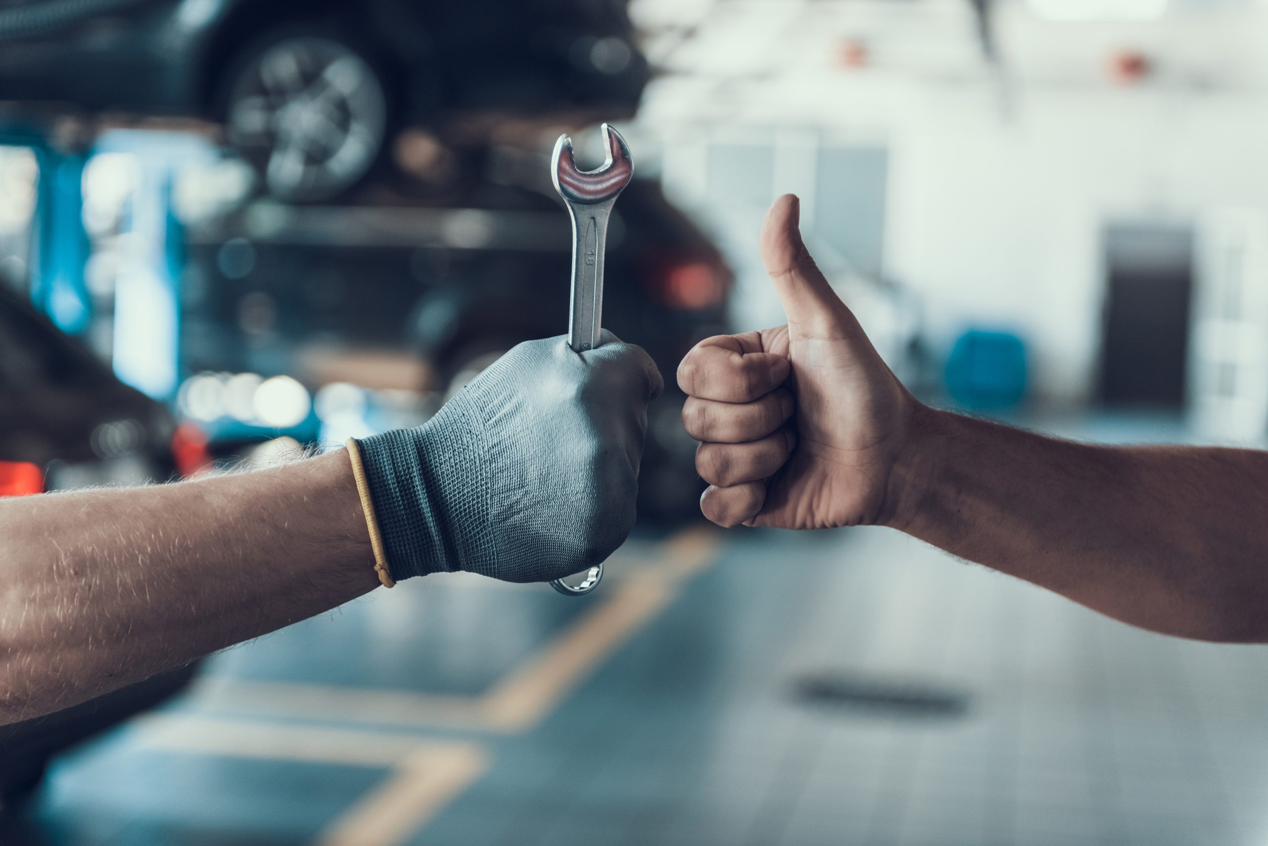 Two mechanics giving each other a thumbs up
