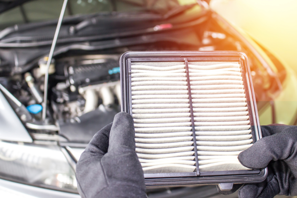 A service technician replacing an air filter