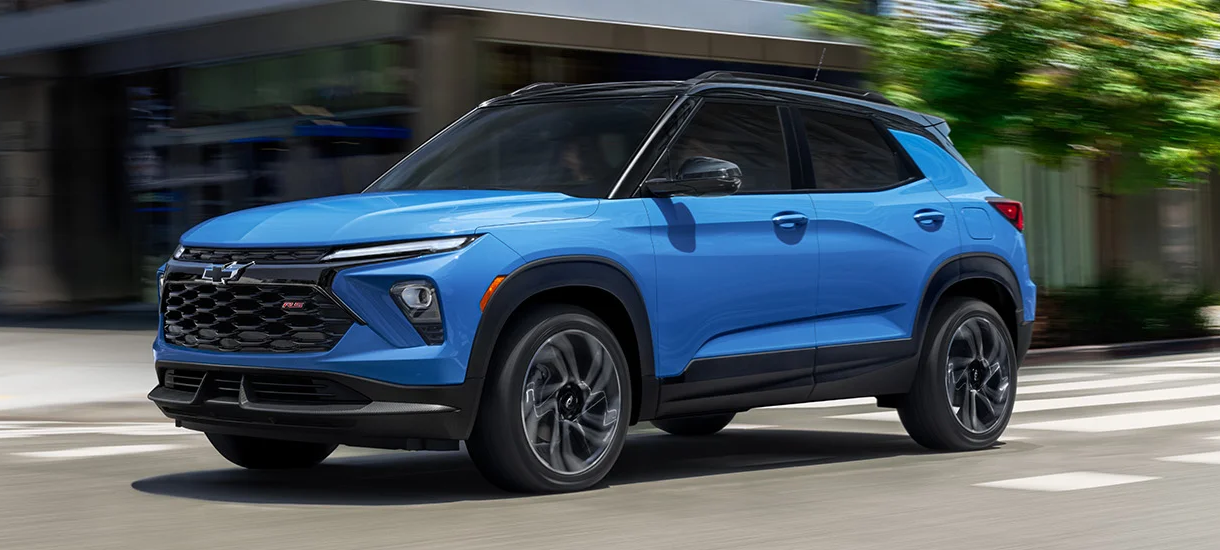 A 2024 Chevy Trailblazer in stunning blue driving on an urban street