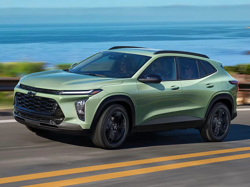 The 2025 Chevrolet Trax driving next to a beautiful lake
